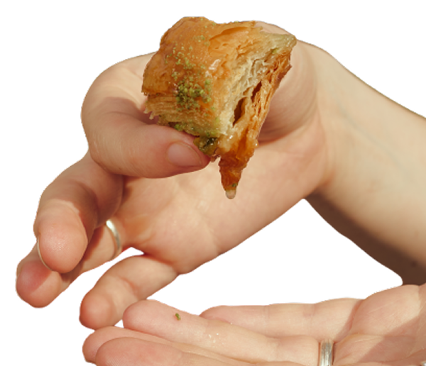 A hand holding a piece of Good Baklava